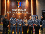Official Group Portrait Beneath Propam Emblem